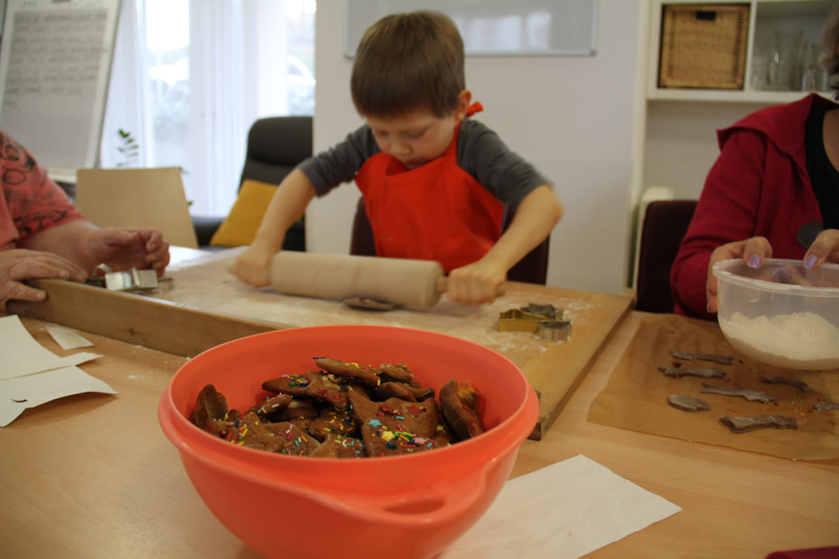 Kindergartenkinder zu Besuch bei AWIK - hier backen sie mit älteren Menschen Kekse bzw. stechen sie aus dem Teig aus