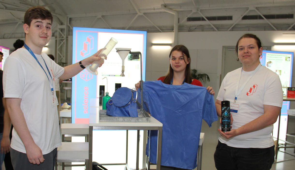 Johannes Schneider, Vanessa Moosmann und Robin Pregler haben einen sauberen Imprägnierspray entwickelt, dessen Wirkung sie immer wieder vorführen - draufgeleertes Wasser perlt ab