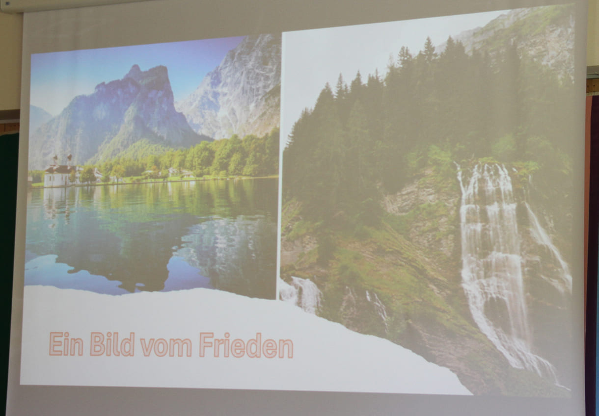 Zwei Schülerinnen präsentierten eine Geschichte mit zwei Bildern vom Frieden