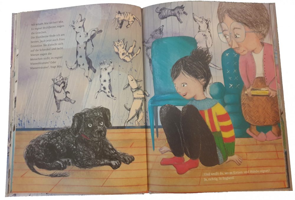 Doppelseite aus dem Bilderbuch "Weißt du, wo es Katzen und Hunde regnet"