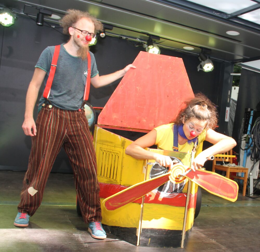 Eva Zarbl (rechts) und Andi Geyer (links) als Clownin Paula und Clown Fu mit ihrem hölzernen Flugzeug des Stücks 