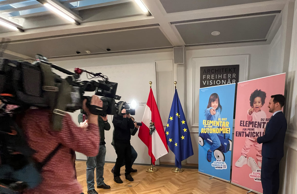 Bildungsminister Christoph Wiederkehr und die Plakate der neuen Image-Kampagne zum Werben um künftige Elementarpädagog:innen und viele Kameraleute