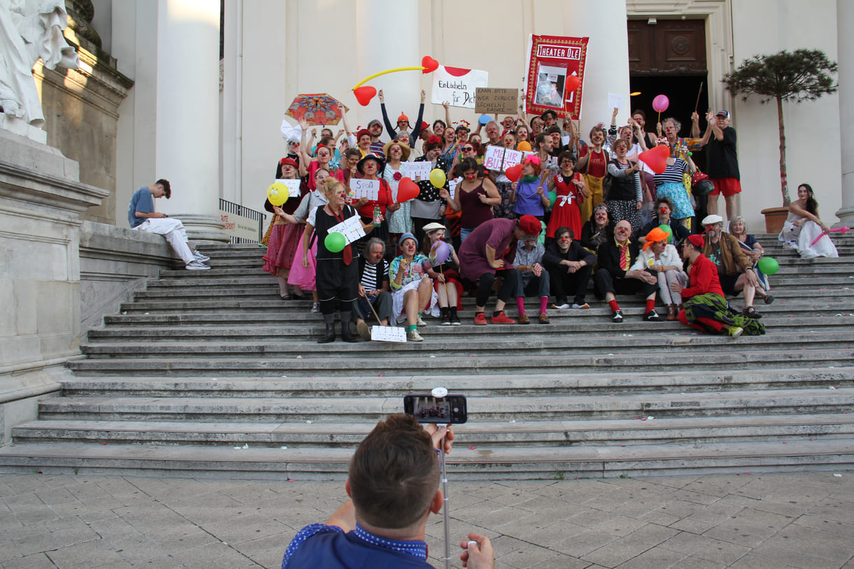 Abschließendes Gruppenfoto aller Clown:innen auf den Stufen hinauf zur Karlskirche (Wien)