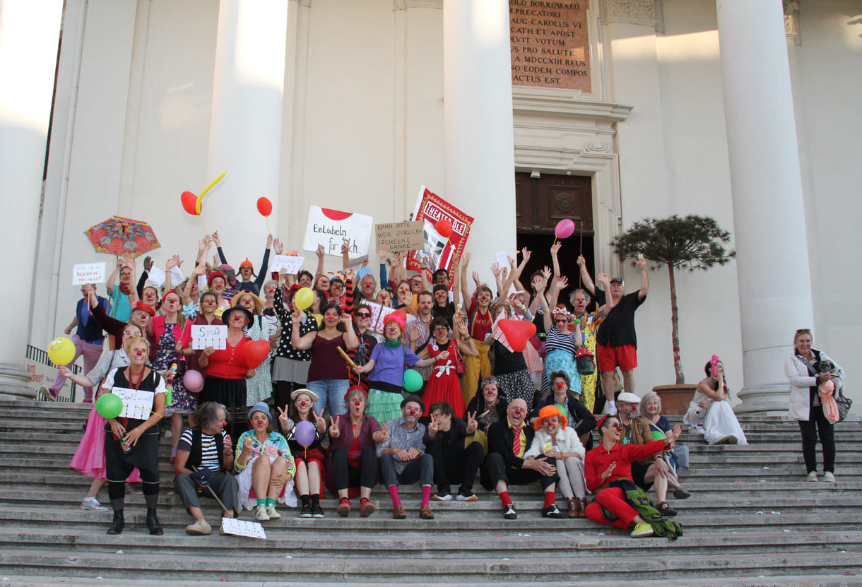 Abschließendes Gruppenfoto aller Clown:innen auf den Stufen hinauf zur Karlskirche (Wien)