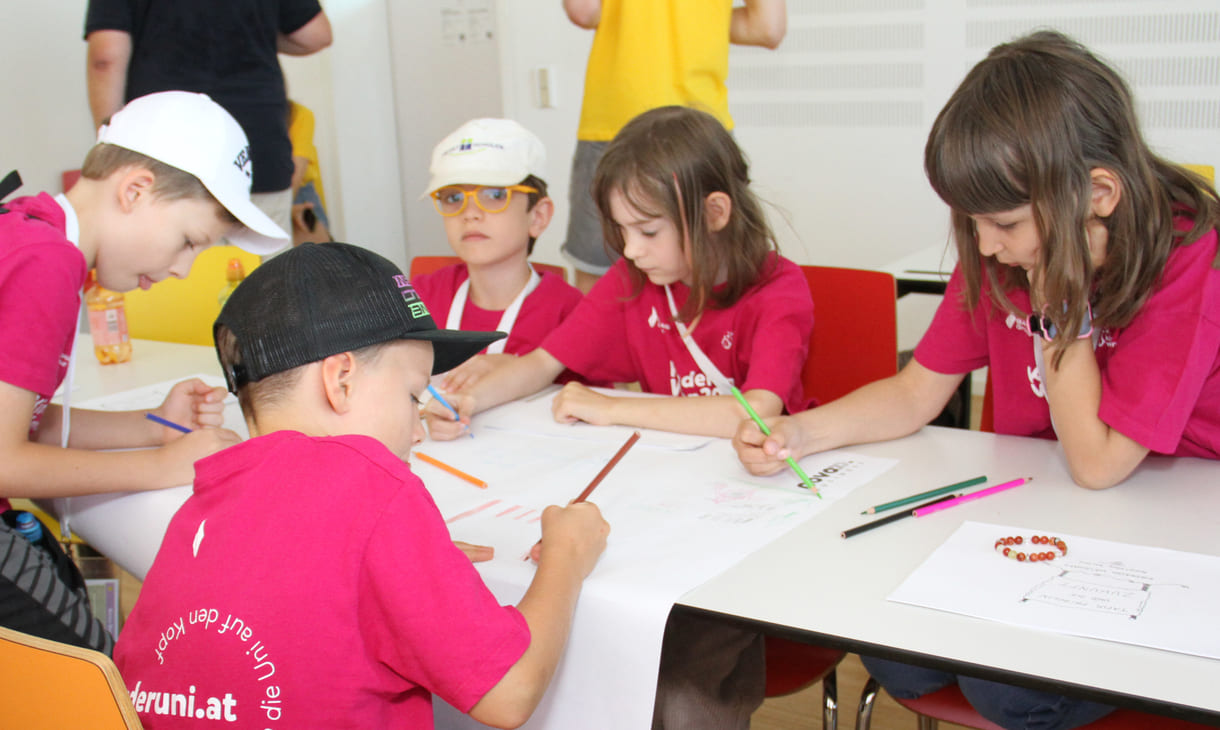 Meist in Gruppen zeichnen und schreiben Kinderuni-Studierende Ideen für die Weiterentwicklung von Tapir Fridolins Kaufmannsladen