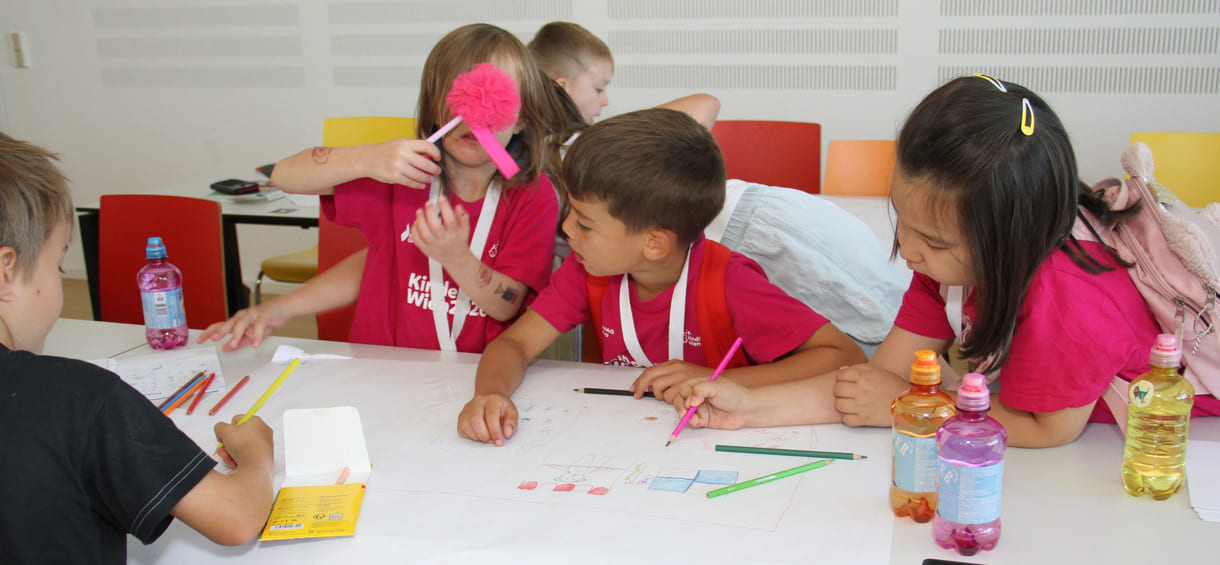 Meist in Gruppen zeichnen und schreiben Kinderuni-Studierende Ideen für die Weiterentwicklung von Tapir Fridolins Kaufmannsladen