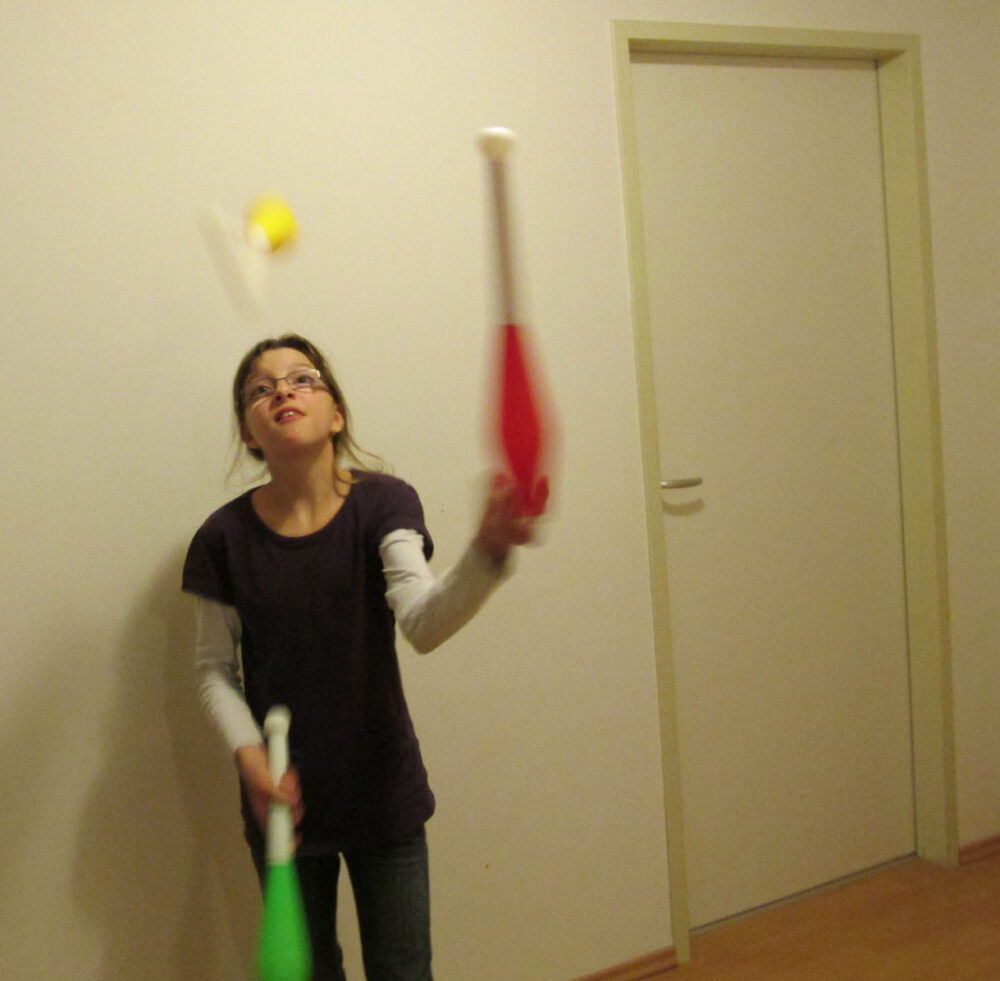 Anna Käferböck beim Jonglieren als Kind zu Hause