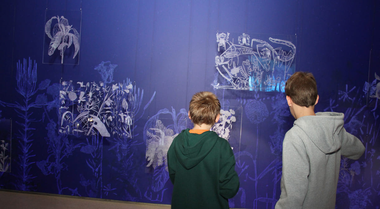 In der Ausstellungshalle ist eine ganze Wand für Kreidezeichnung der Besucher:innen reserviert