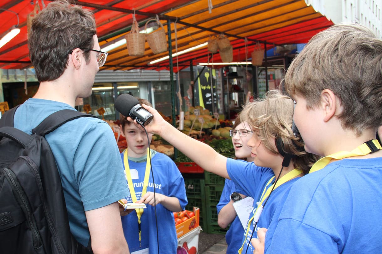 Junge Radiomacher:innen bei Interviews am Brunnenmarkt