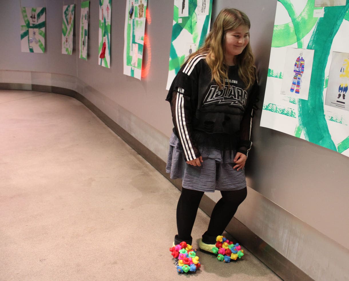 Mia Meier mit ihrer Zeichnung - und hier auch zu sehen die eigenhändig fabrizierte Verzierung ihrer Schuhe