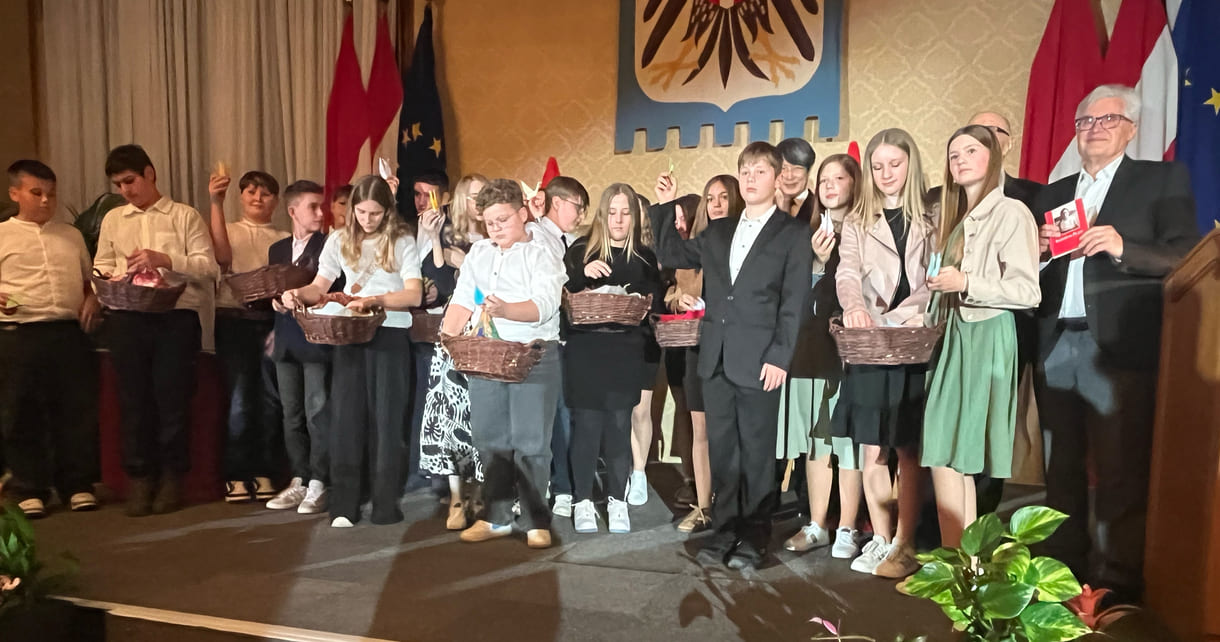 Mittelschüler:innen aus Seitenstetten Biberbach auf der Bühne mit Körben voller eigenhändig gefalteter Papierkraniche