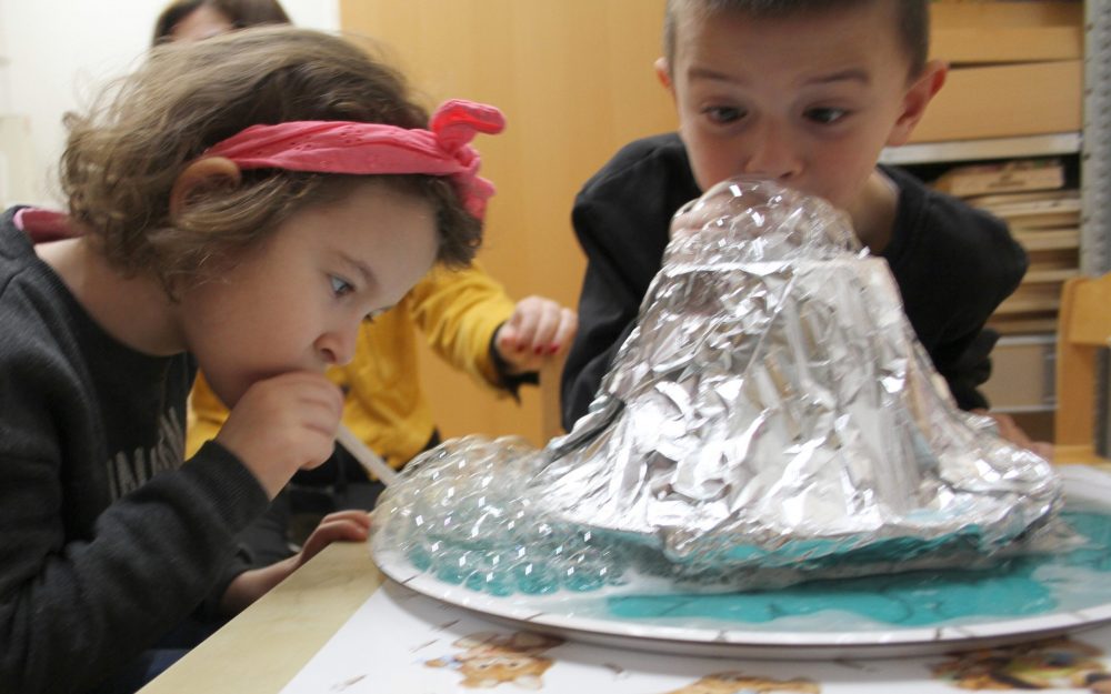 Kinder experimentieren und bauen einen Vulkan