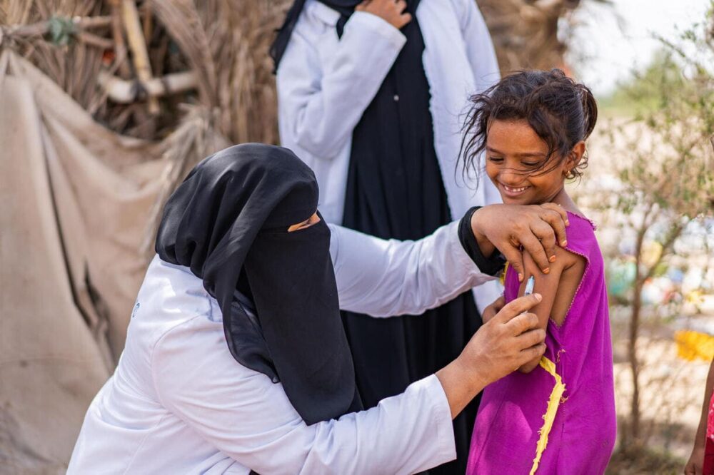 Am 6. Juni 2022 impft der Gesundheitshelfer Ghada Ali Obaid, 53, im Gouvernement Aden, Jemen, den 9-jährigen Aswar Saddiq Othman während einer Impfkampagne für Kinder in der Gemeinde.