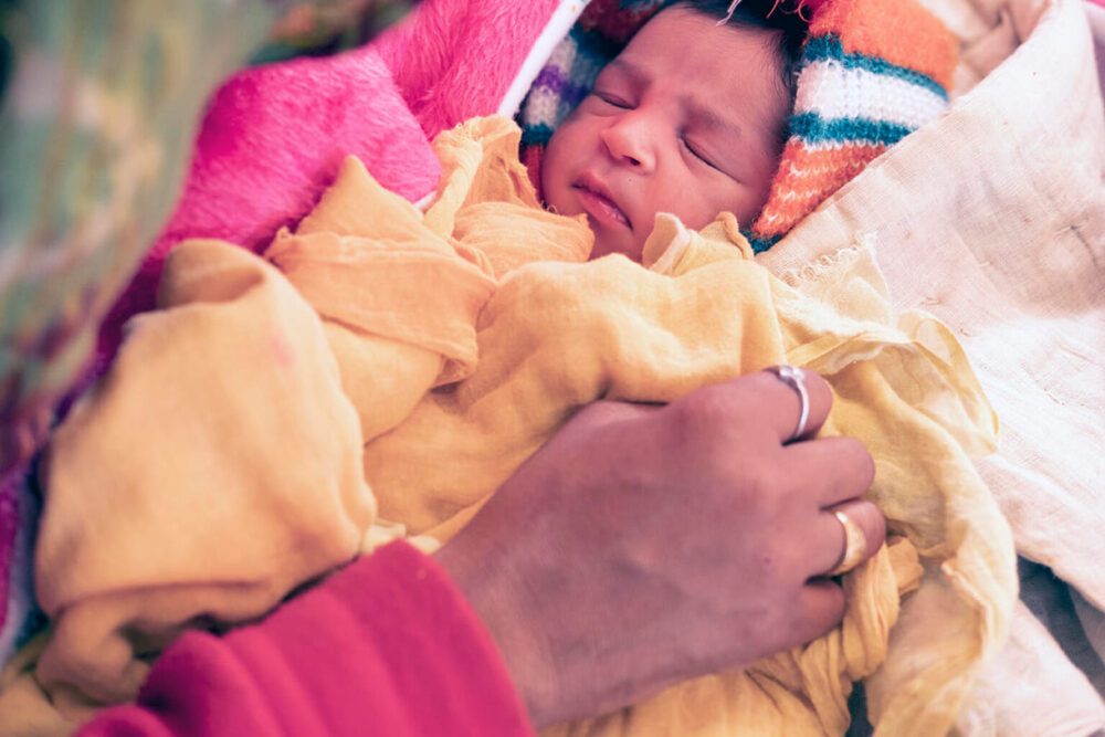 Ein Neugeborenes auf der überfüllten JSSK-Station im Dungapur District Hospital (Indien)